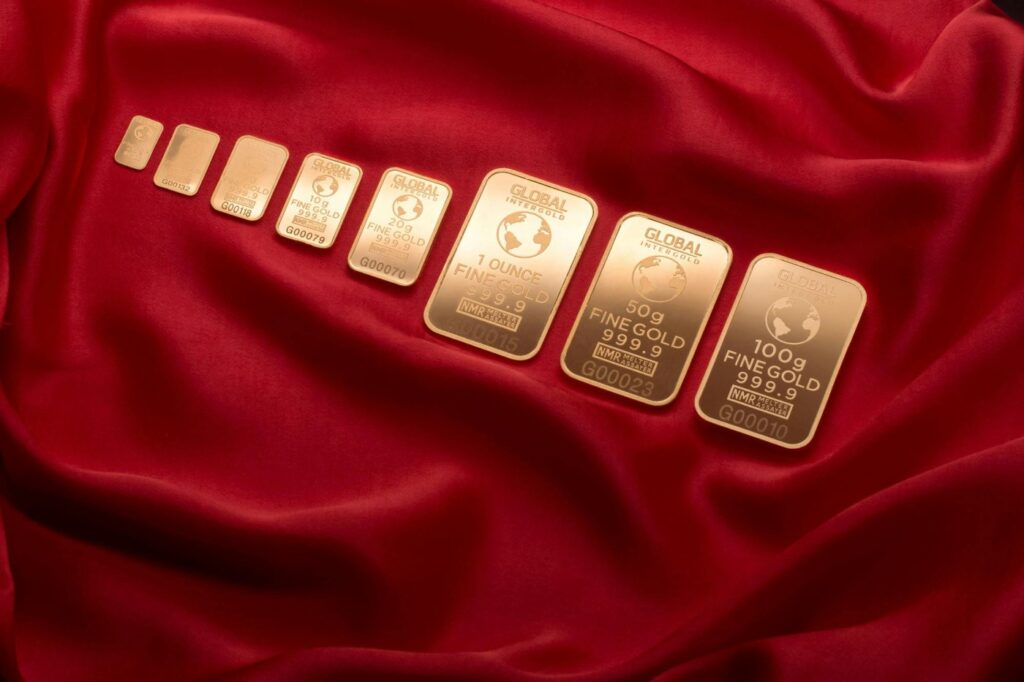 eight pieces of gold on a red cloth to depict gold investment in ghana